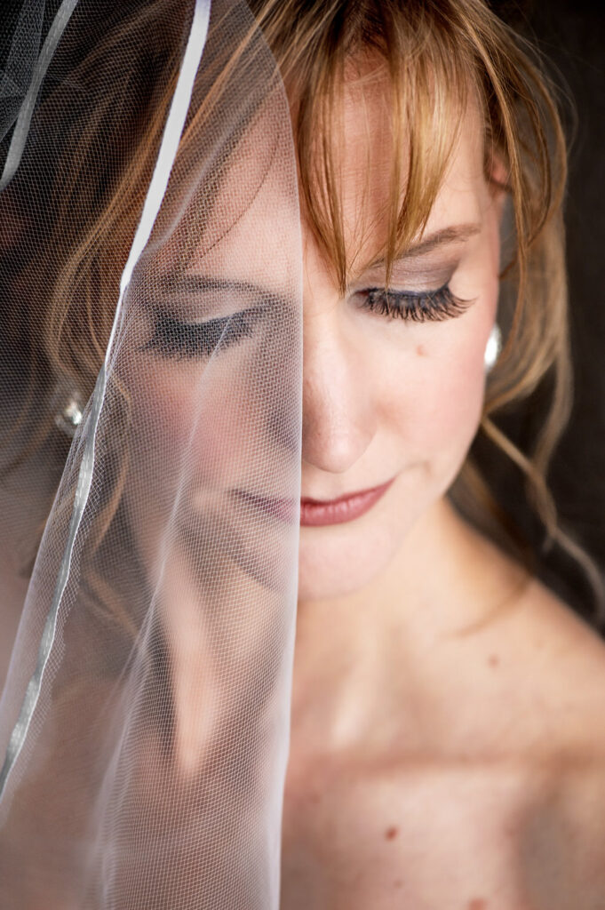Closeup shot of bride with veil partially covering her face