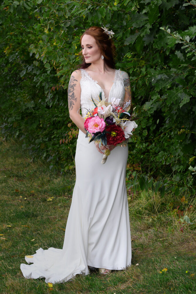 A bride holding a colorful bouquet of flowers. 